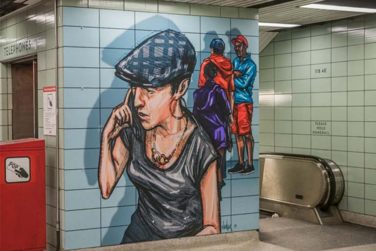 Mural of a woman on a cellphone, located in a TTC station