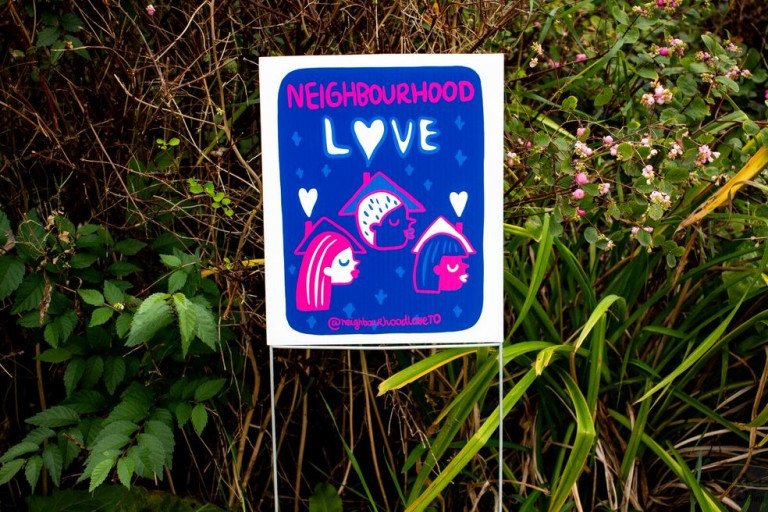 Image of a small lawn sign reading Neighbourhood Love