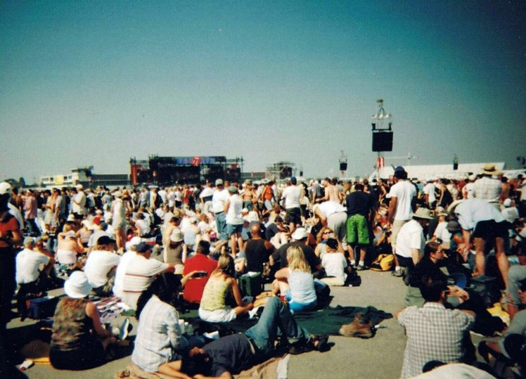 Image of a large crowd looking at a small stage in the background.