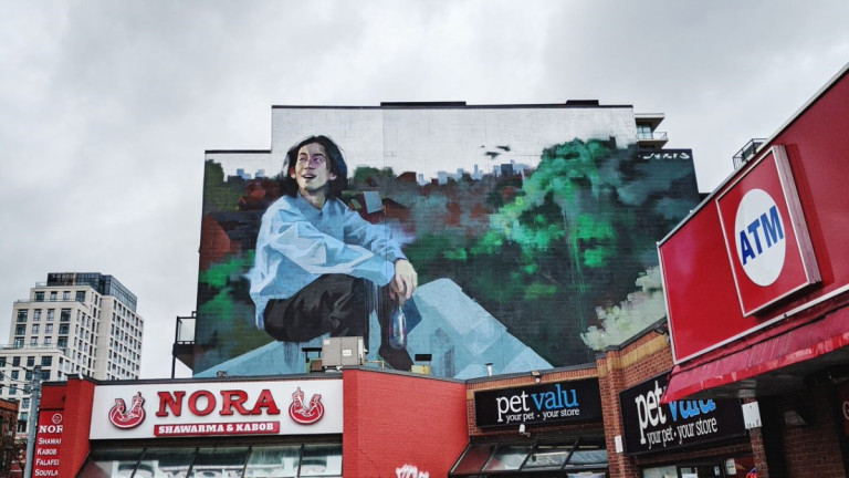 Large mural of a man above a plaza