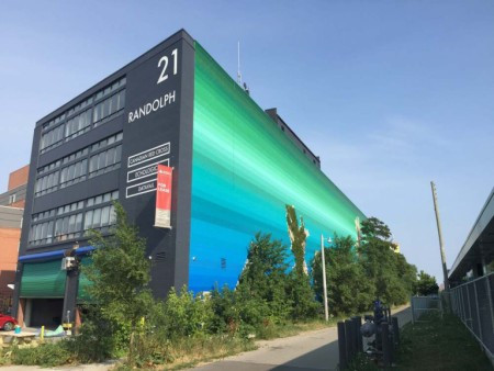 Image of a large mural of a colour gradation from sky blue to green